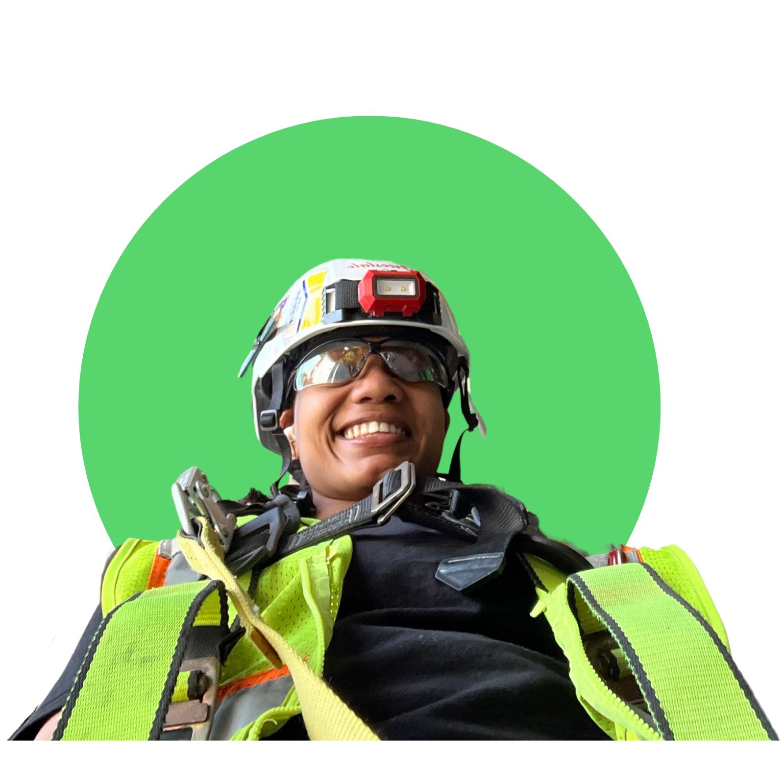 Asia Braxton smiles down at the camera, wearing a hardhat and safety goggles. 