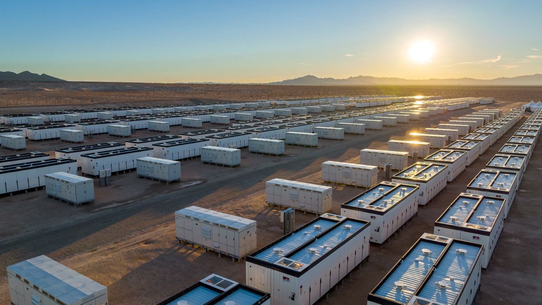 Battery storage system on open land at sunrise