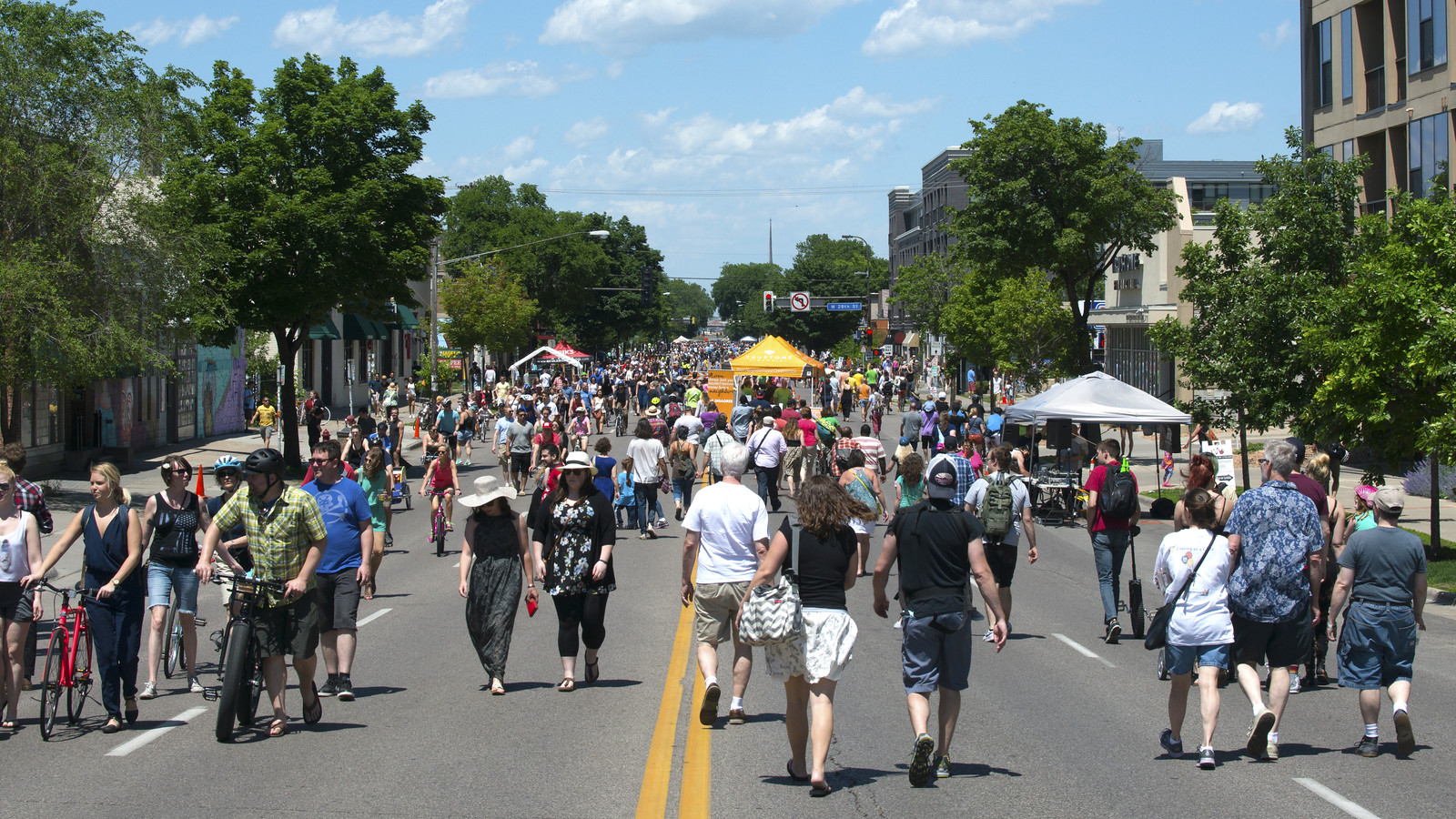 Hundreds of people walking and biking on a street in Minnesota.